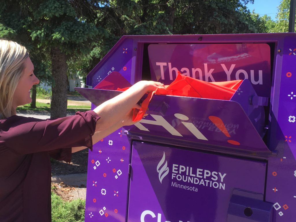 Woman making a donation to a drop bin