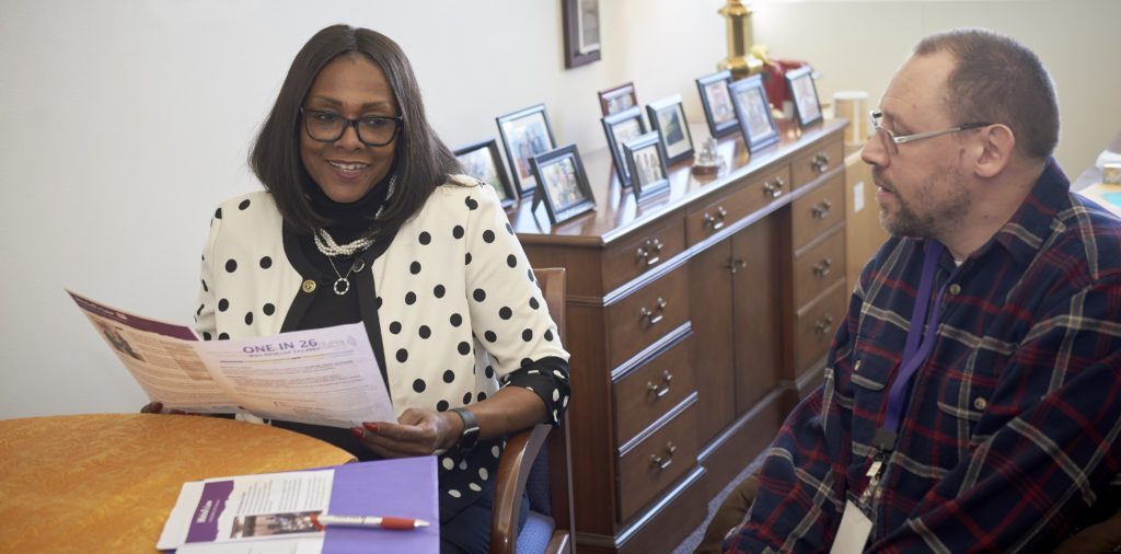 A representative meets with her constituent in her office