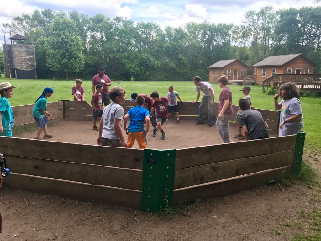 Camper play game inside a wooden arena