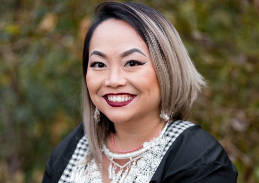 Hmong woman dressed up and smiling