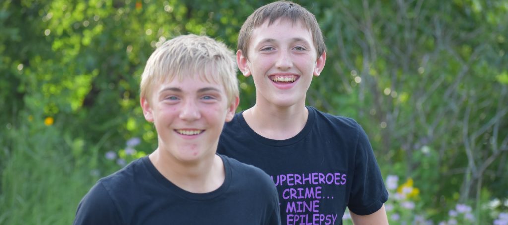 Two boys walking outside and smiling