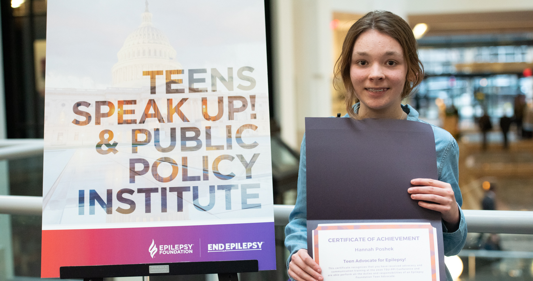 Teenage girl holding advocacy certificate
