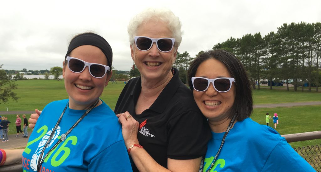 three women smiling at camera at fundraising walk event