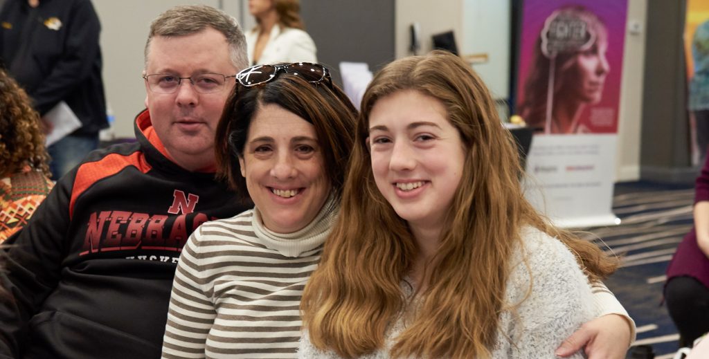 dad mom and teenage daughter together and smiling