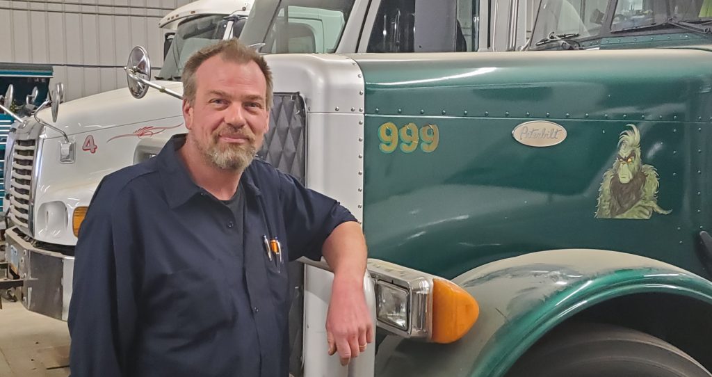 Adult male arm on semi truck smiling