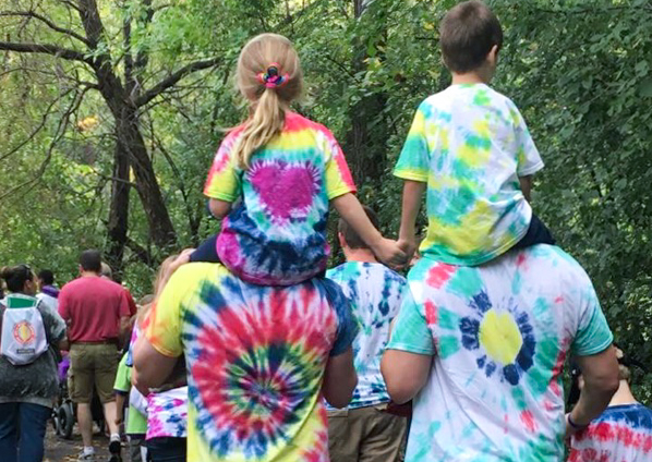 Two young kids on parents shoulders