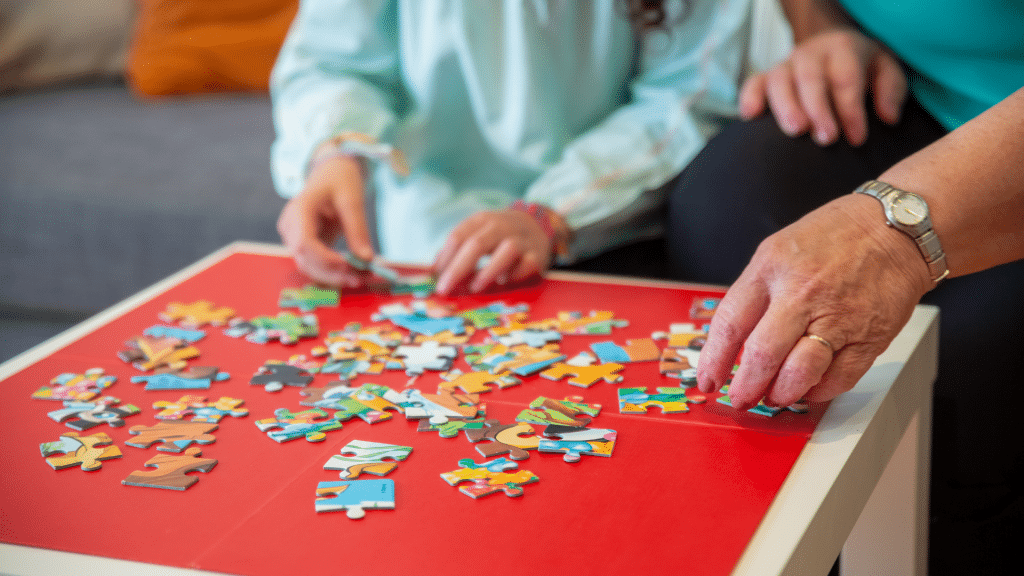 two people connecting puzzle pieces