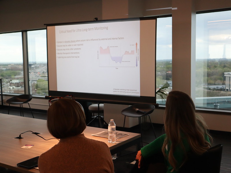EpiForum attendees looking at projector screen slide as they listen to presentation from Epilepsy specialists