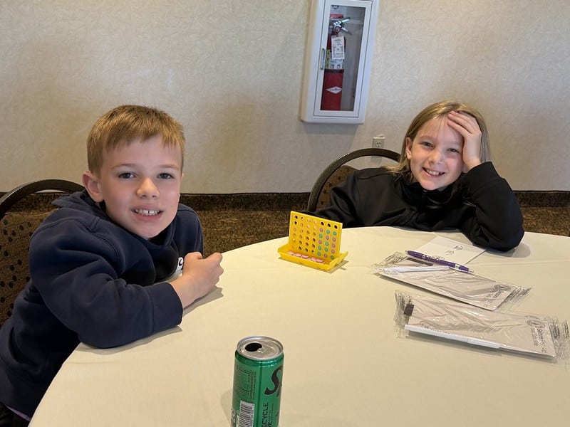 Attendees pose for a photo at the event while playing Connect Four