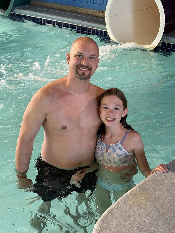 Attendees posing for picture by the waterslide at the waterpark
