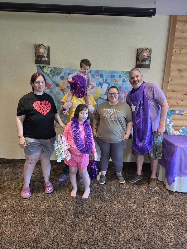 Attendees pose for a photo at the event's pool day themed photo booth
